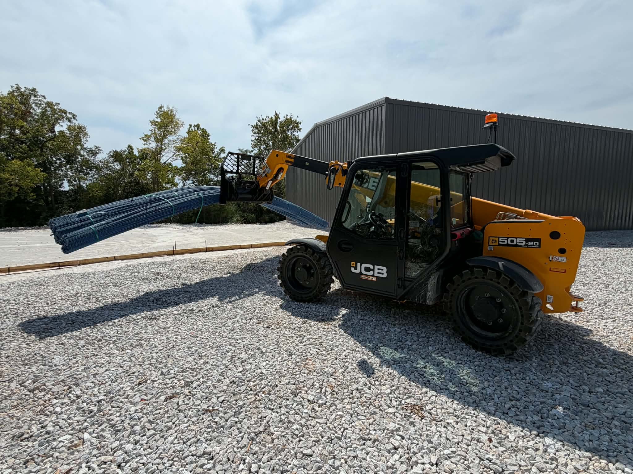 Newline Supply RAM truck with flatbed trailer loaded with rebar